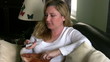 Woman watching tv and eating chips
