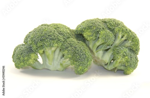 Photo: Two pieces of fresh broccoli isolated on white Two pieces of fresh broccoli isolated on white