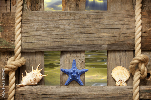 Photo: Starfish at sea on beach on vintage boards marine background Starfish at sea on beach on vintage boards marine background