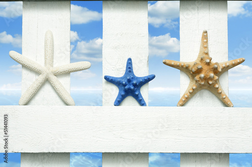 Photo: Starfish at sea on beach on vintage boards marine background Starfish at sea on beach on vintage boards marine background