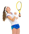 Happy female tennis player with racket rejoicing success