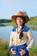Beautiful Smiling Cowgirl front of lake