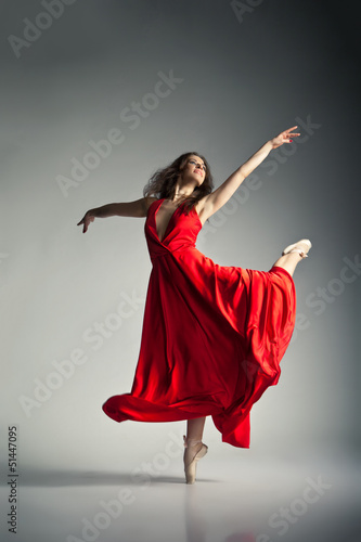 Photo: Ballet dancer wearing red dress over grey Ballet dancer wearing red dress over grey
