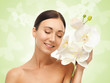 Foto: smiling woman with white orchid flower smiling woman with white orchid flower