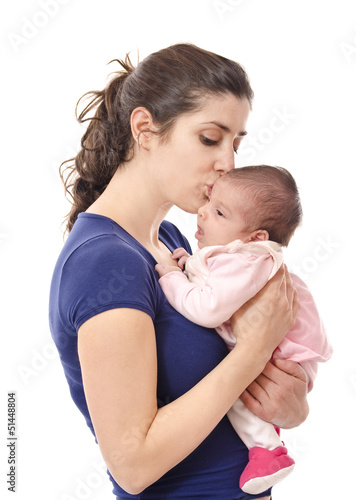 Photo: Mum kissing newborn. isolated over white. Mum kissing newborn. isolated over white.