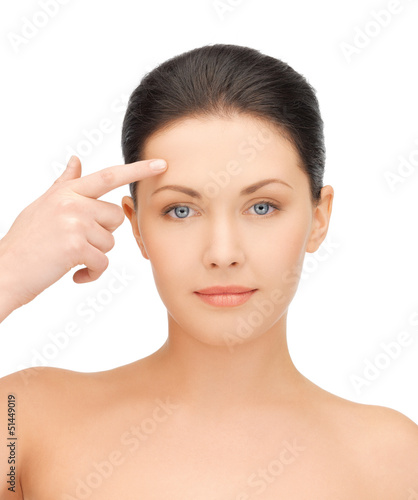Photo: beautiful woman touching her forehead beautiful woman touching her forehead