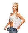 woman showing big pants and holding scales