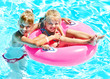 Children sitting on inflatable ring.