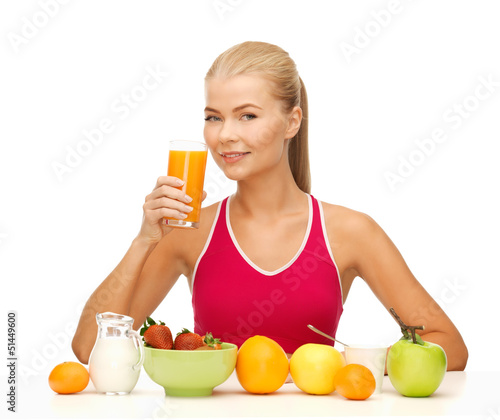 Photo: young woman eating healthy breakfast young woman eating healthy breakfast