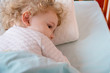 Sick and tired girl liying in bed on pillow
