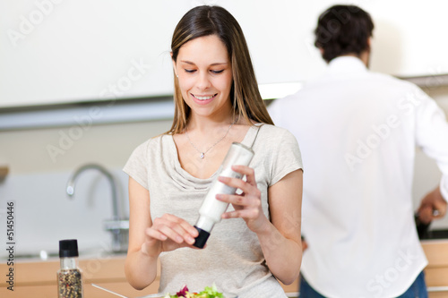 Photo: Woman preparing a salad in the kitchen Woman preparing a salad in the kitchen