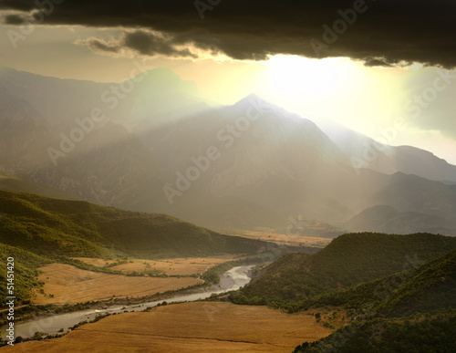 dramatic sky on the valley of the Vjosa River at the sunset, Albania