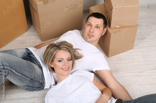 Photo: Young couple moving in new house Young couple moving in new house