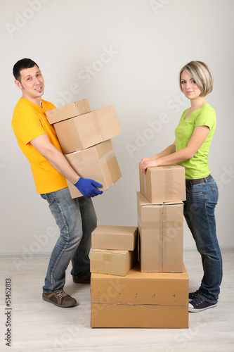 Photo: Young couple moving in new house Young couple moving in new house