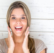 Portrait of an excited woman looking surprised