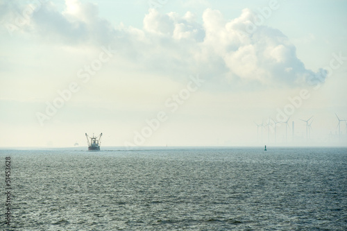 Photo: Industrial harbor with wind turbines and fishing boat Industrial harbor with wind turbines and fishing boat