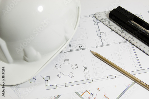 Photo: Blueprint for construction work with helmet and tools Blueprint for construction work with helmet and tools