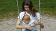 HD1080 7 Month old Baby with mother sitting on a swing.