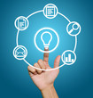 Foto: Hand pointing to business icons Hand pointing to business icons