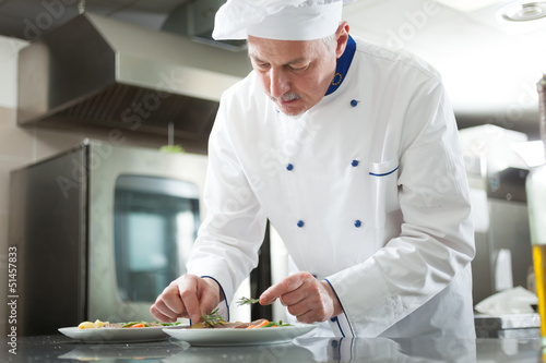 Photo: Chef garnishing a dish Chef garnishing a dish