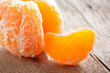 Peeled tangerine on wooden table