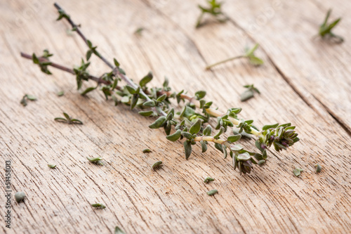 Photo: Thyme sprigs over wooden table Thyme sprigs over wooden table