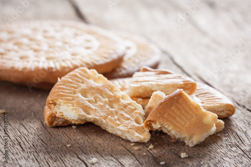 Photo: Crushed biscuit on wooden table Crushed biscuit on wooden table