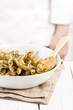 Cook behind a penne rigate al pesto dish