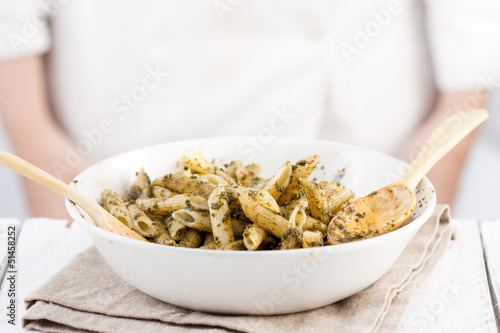 Photo: Cook behind a penne rigate al pesto dish Cook behind a penne rigate al pesto dish