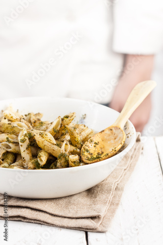 Photo: Cook behind a penne rigate al pesto dish Cook behind a penne rigate al pesto dish