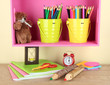 Photo: Colorful pencils in pails on shelf on beige background Colorful pencils in pails on shelf on beige background