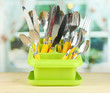 Knives, spoons, forks in plastic container for drying,