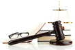 Golden scales of justice, gavel and books isolated on white