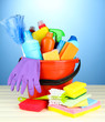 Cleaning items in bucket on  color background