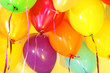Many bright balloons under ceiling close-up
