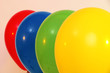 Four bright balloons on light background