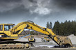 Photo: giant bulldozers in action, dark clouds moving in giant bulldozers in action, dark clouds moving in