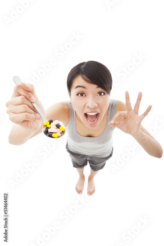 Photo: young woman holding pills with ok gesture young woman holding pills with ok gesture