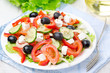 Greek salad with feta cheese, olives and vegetables, horizontal