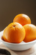 Photo: orange in white plate on wooden background orange in white plate on wooden background