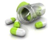 green medicine pills from glass bottle on the white