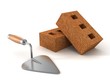 Bricks and a mason's trowel on a white background