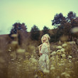 Vintage photo of beautiful girl in spring field