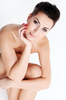 Young naked woman evening makeup sitting