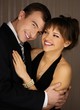 Photo: Happy young elegant couple in classic dress embracing Happy young elegant couple in classic dress embracing