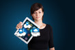 young woman holding tablet with modern devices in clouds