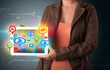 Girl presenting a tablet with colorful social icons and signs