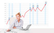 Young businesswoman calculating stock market with rising graph i