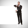 Portrait of business man showing blank signboard