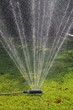 Garden sprinkler on lawn, Spain © Arena Photo UK